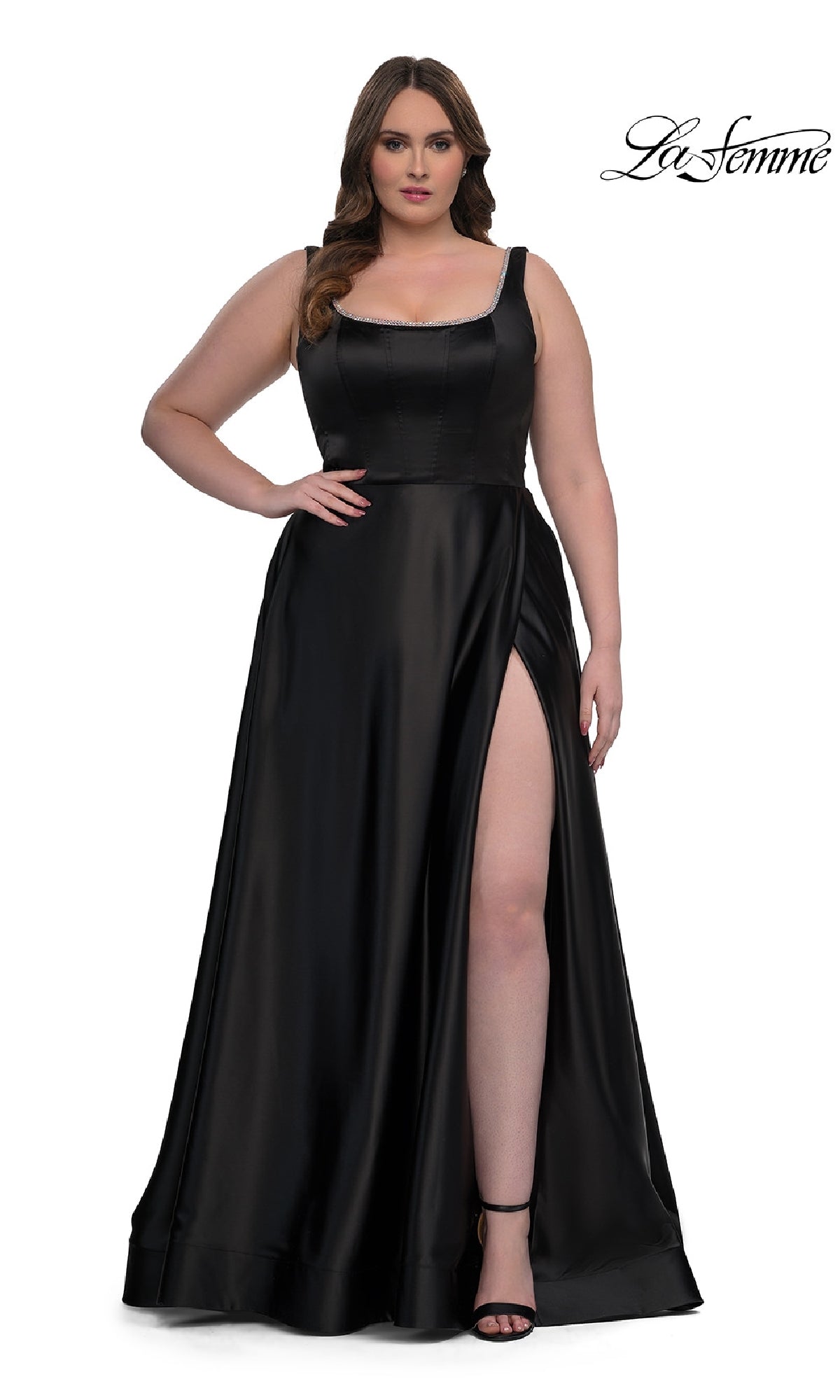 A woman wearing the Plus-Size Classic Long Prom Gown: La Femme 33026, a sleeveless floor-length satin dress with a thigh-high slit, stands against a white background.